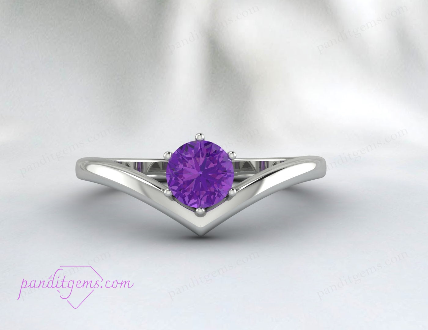 A minimalist sterling silver ring with a round amethyst gemstone, designed in a V-shape band for a unique, elegant style.