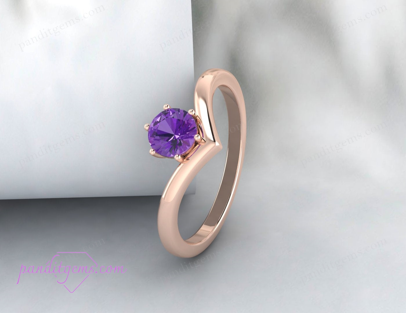 A round purple amethyst set in a chevron silver band, offering a modern twist on classic solitaire rings.