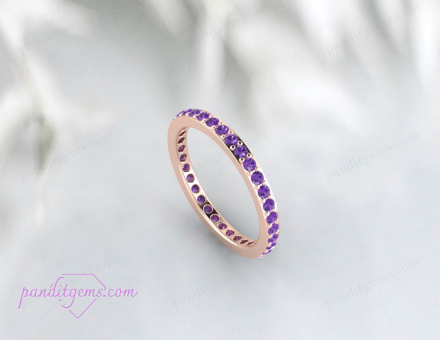 Amethyst eternity band with round purple gemstones in 14k rose gold. A thin, delicate stacking ring perfect for February birthstone gifts.