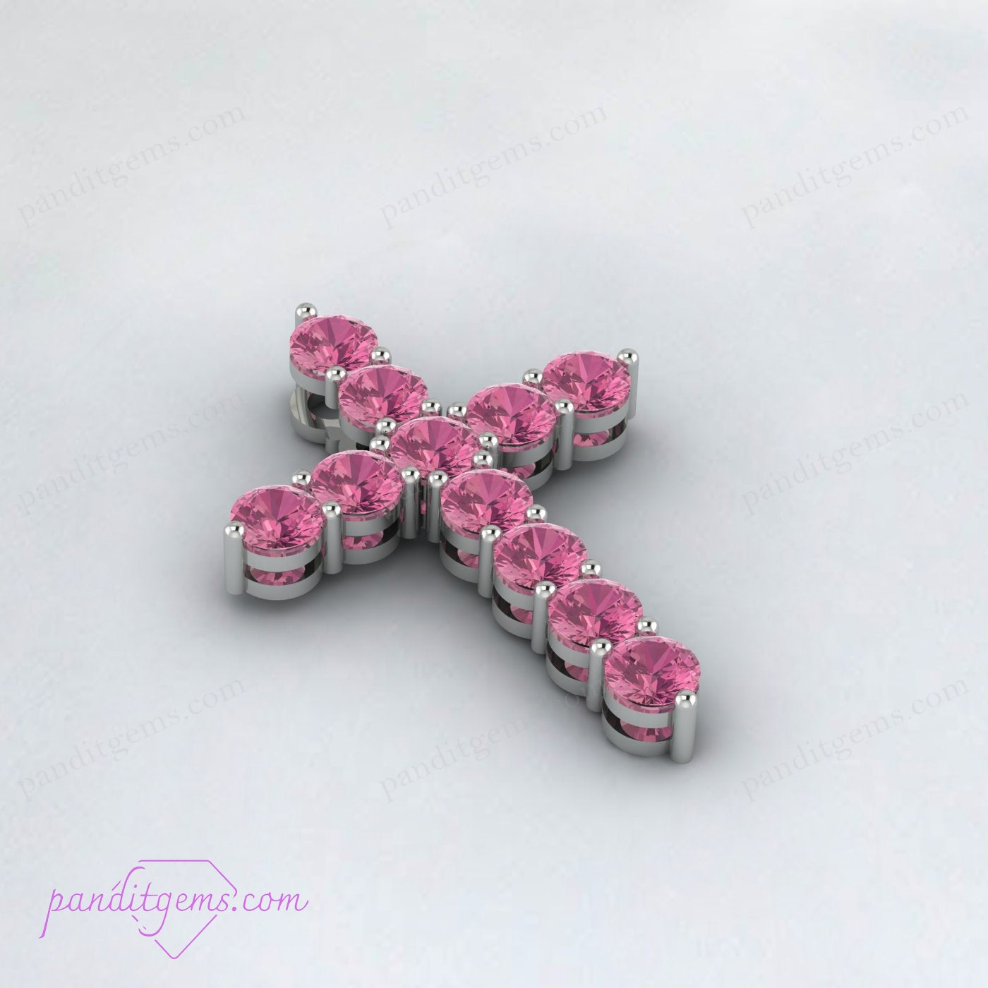 Close-up of a sterling silver cross necklace featuring a Pink Tourmaline stone, emotional healing.