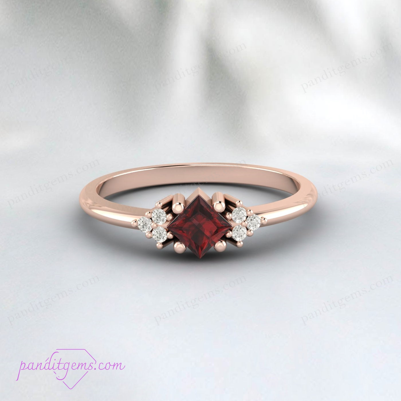 Dark red garnet ring with diamonds in a vintage-inspired setting, perfect for special occasions.