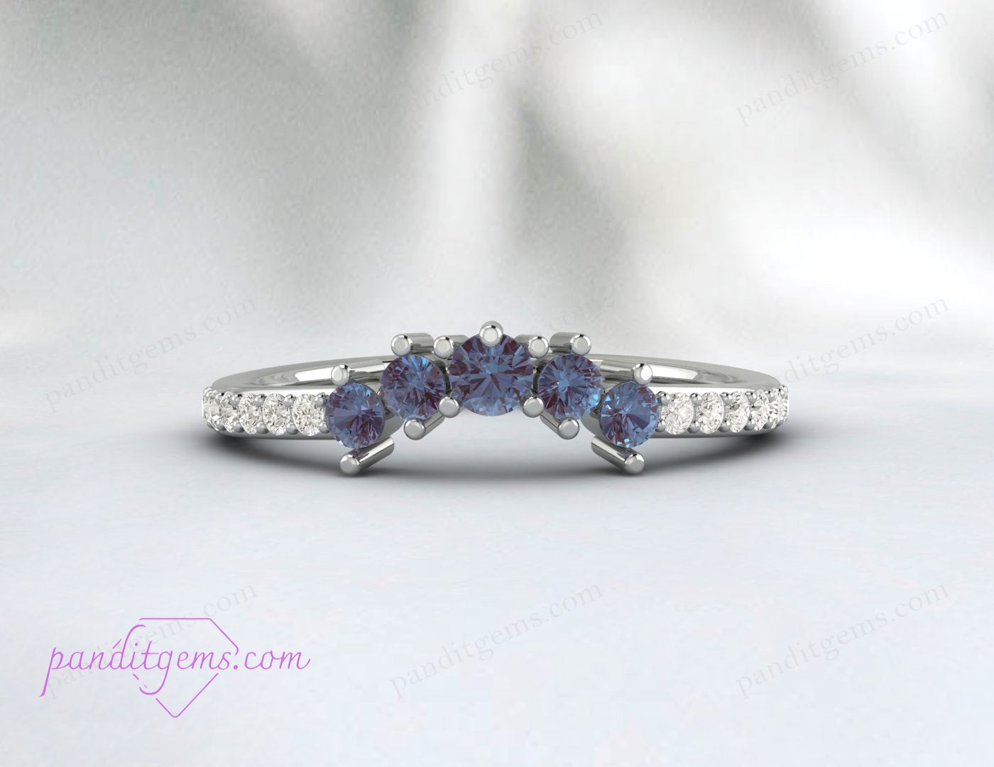 A rose gold wedding band with a curved V design, featuring Alexandrite gemstones.
