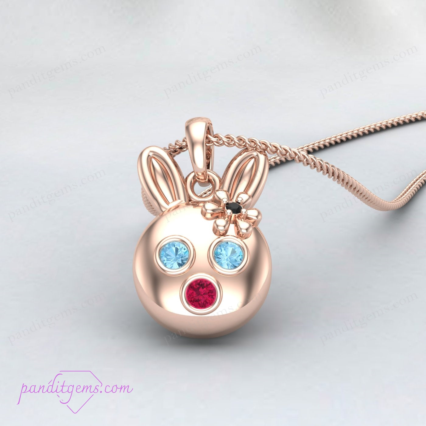 Sterling silver bunny pendant necklace with Aquamarine, Ruby, and Onyx gemstones, perfect for animal lovers.