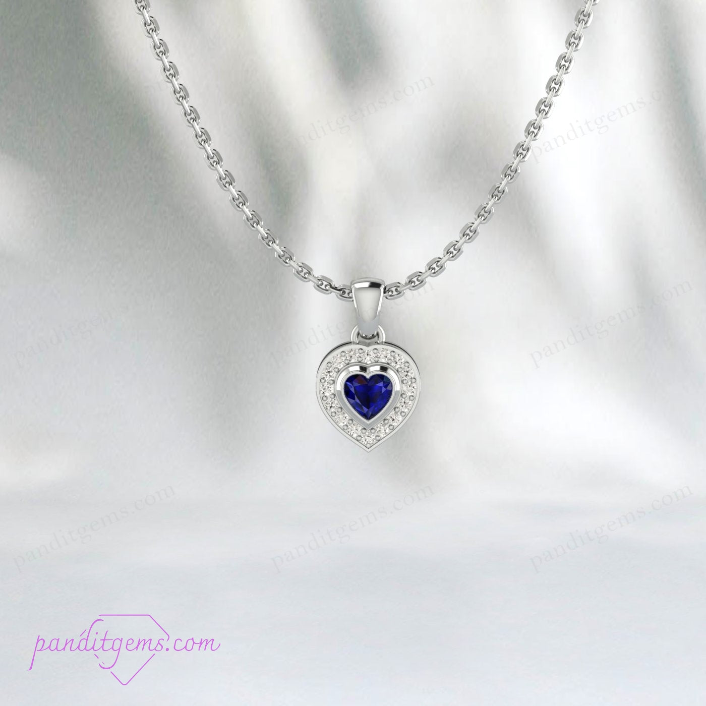 Sterling silver heart pendant with 7mm blue sapphire surrounded by a CZ halo.