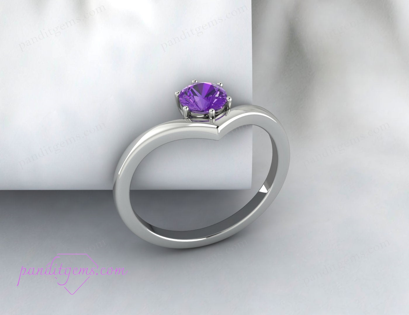 Top-down view of the V-shaped chevron ring with a round purple amethyst gemstone, set in polished sterling silver.