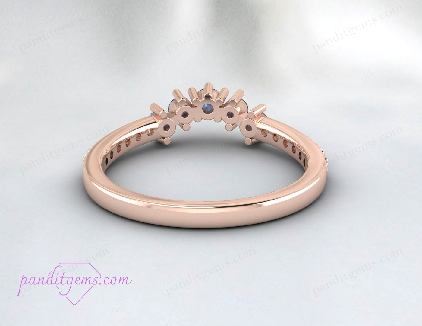 A vintage-style curved wedding band with a color-changing Alexandrite stone.
