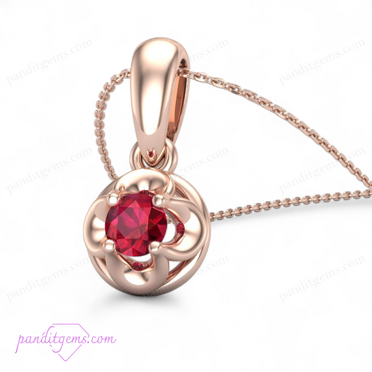 A delicate gold necklace featuring a round cut ruby prong-set in a minimalist solitaire design.