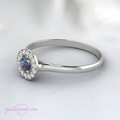 Halo engagement ring with Alexandrite and simulated diamonds.