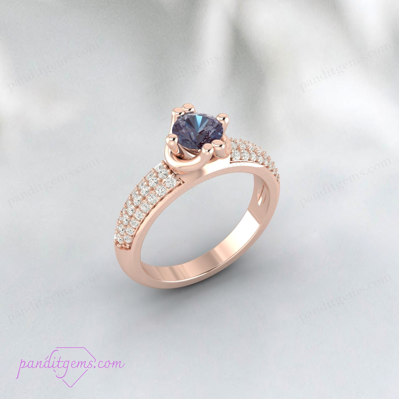 Alexandrite and simulated diamond anniversary ring in yellow gold plating.