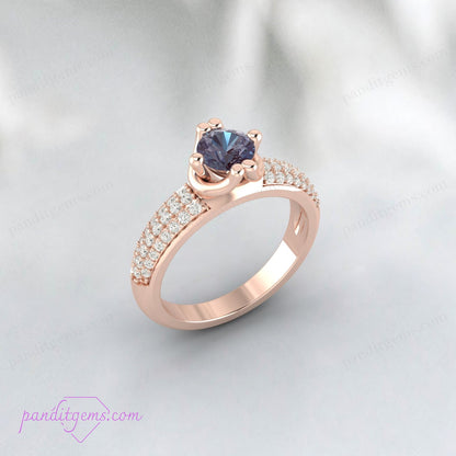 Alexandrite and simulated diamond anniversary ring in yellow gold plating.