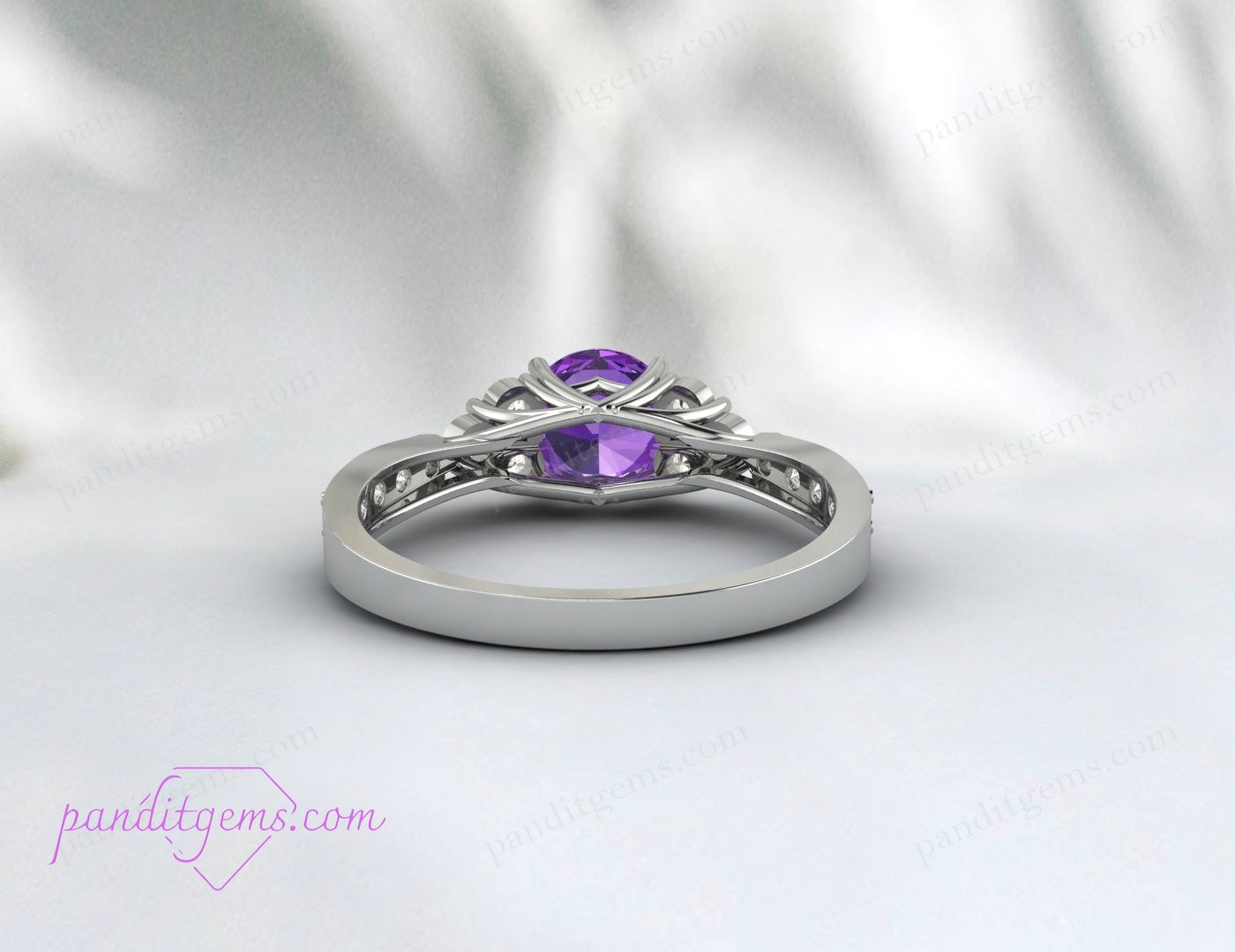 Amethyst ring with a rich purple hue, set in a rose gold band, viewed from a side angle.
