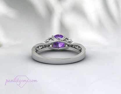 Amethyst ring with a rich purple hue, set in a rose gold band, viewed from a side angle.
