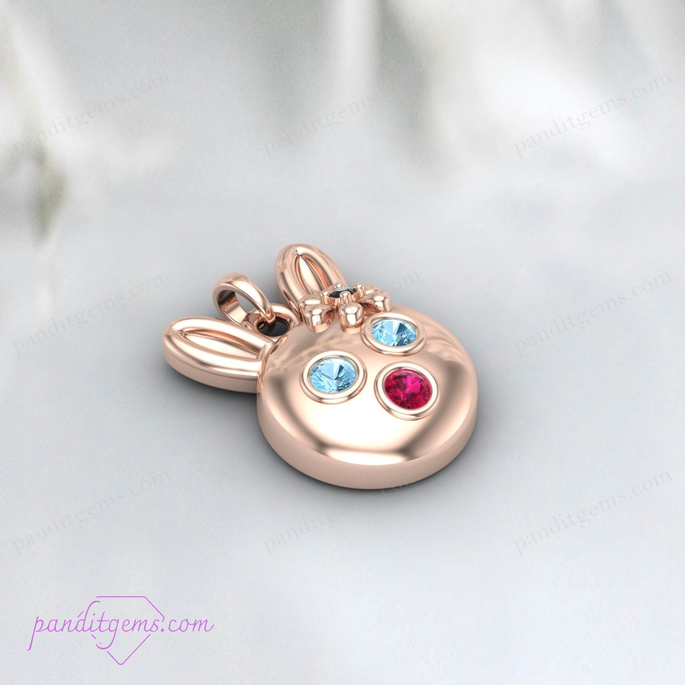 Aquamarine, Ruby, and Onyx adorned bunny pendant on a sterling silver necklace, handcrafted for a whimsical touch.