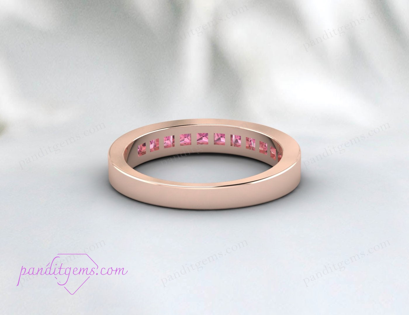 Channel-set pink tourmaline band perfect for a wedding.
