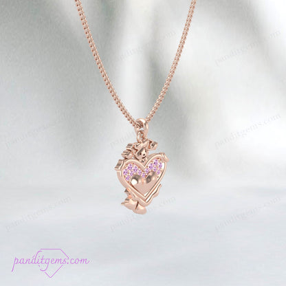 Close-up view of the pink sapphire heart pendant on a gold chain.