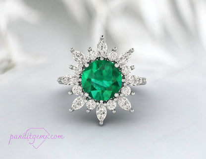 Close-up view of the round cut emerald surrounded by a halo of marquis cut diamonds.