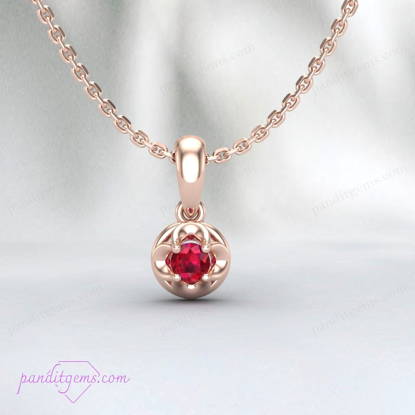 Close-up view of the round ruby pendant, prong-set in 18K gold filled metal.