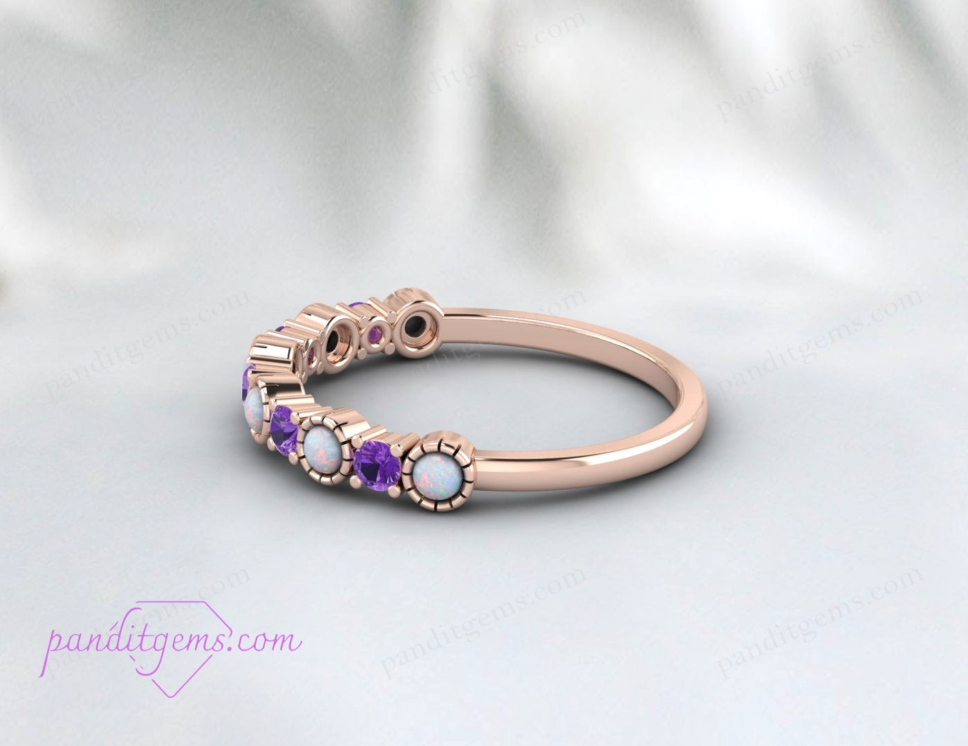 Close-up of a 14K white gold band featuring vibrant amethyst and opal stones, ideal as a birthstone ring.