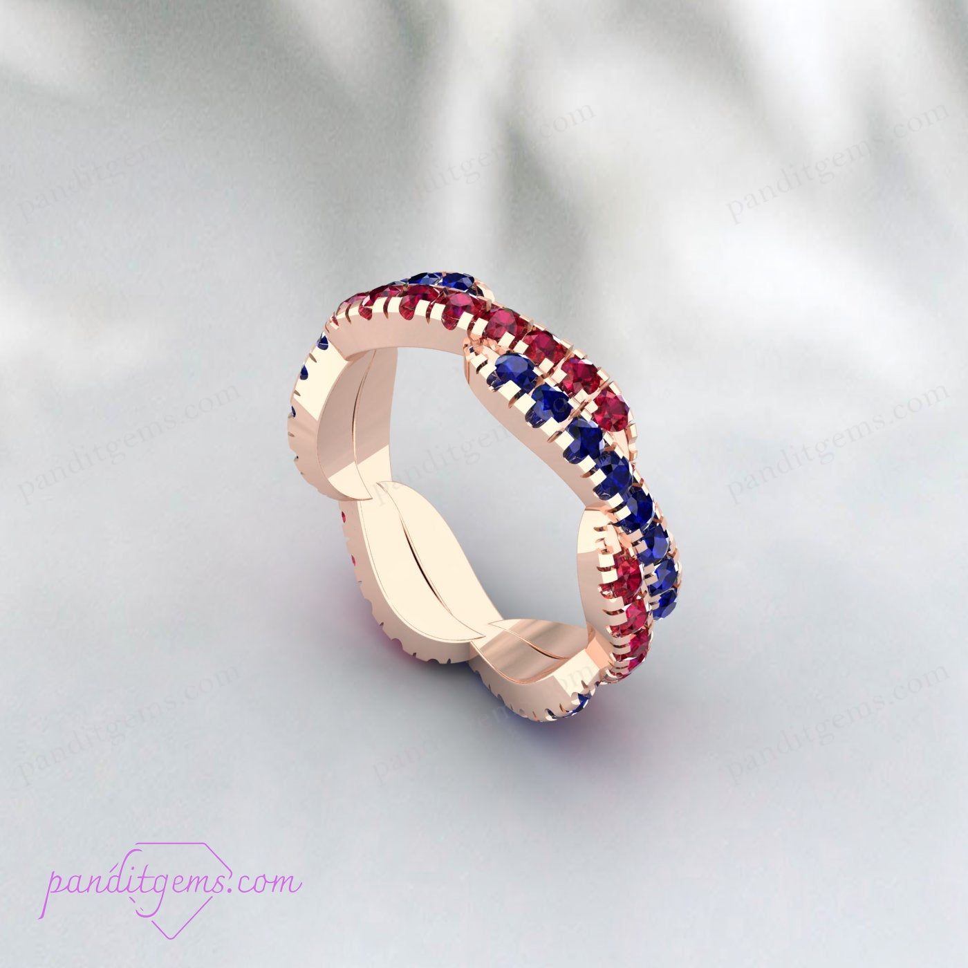 Close-up of a Blue Sapphire and Ruby Infinity Wedding Band, showcasing the intricate twist and brilliant gemstones.