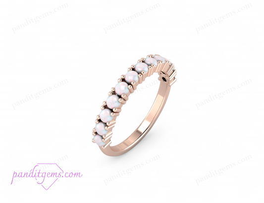 Close-up of a fire opal wedding band in 925 sterling silver with half-eternity design.

