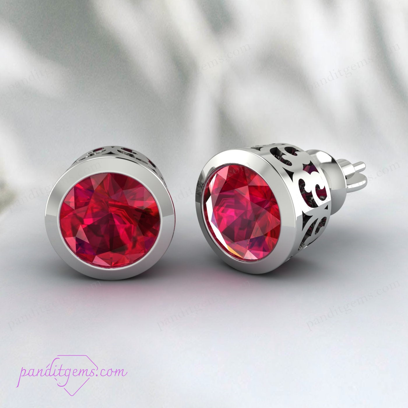 Close-up of filigree design on ruby stud earrings in solid gold.