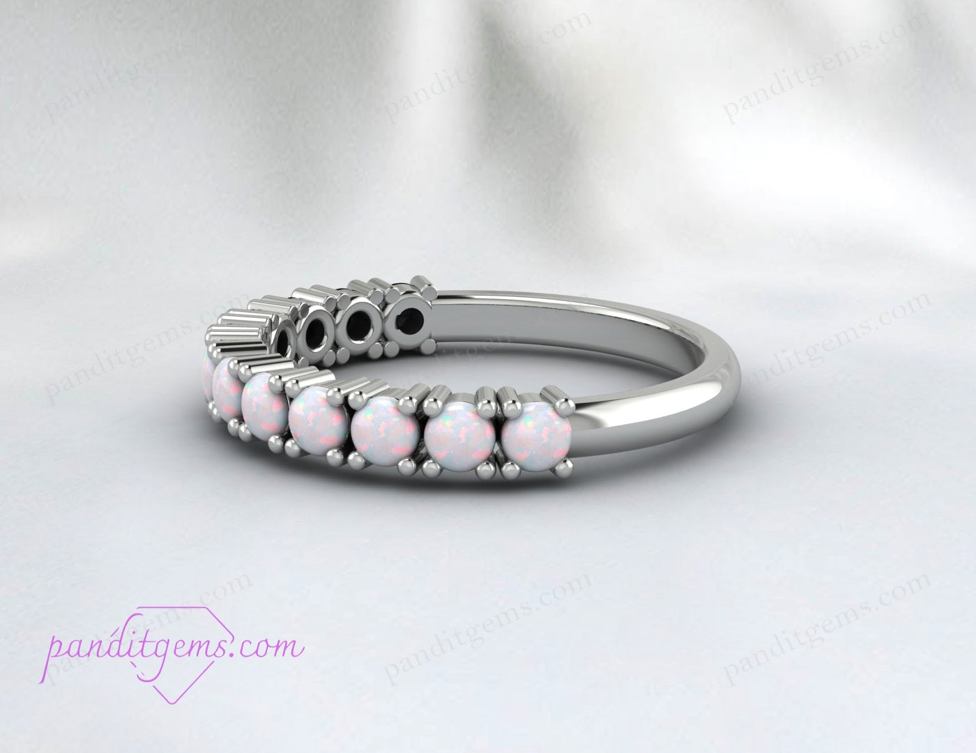 Close-up of natural opal gemstones set in a sterling silver wedding band.
