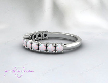 Close-up of natural opal gemstones set in a sterling silver wedding band.

