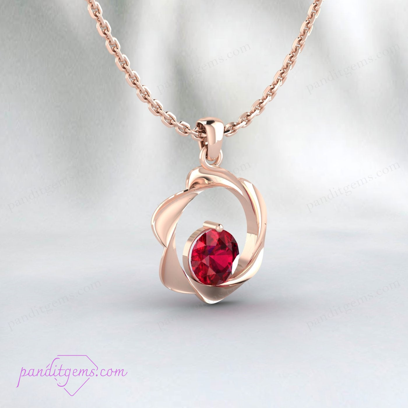 Close-up of round ruby pendant in gold-plated 925 sterling silver setting.