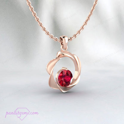 Close-up of round ruby pendant in gold-plated 925 sterling silver setting.