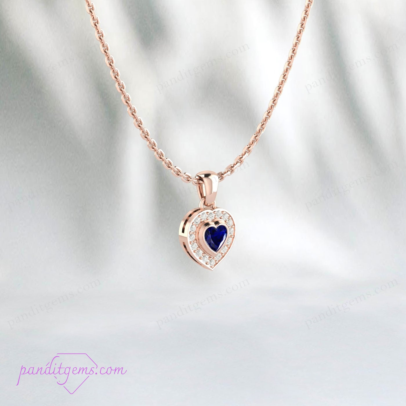 Close-up view of Blue Sapphire Heart Pendant, set in sterling silver with CZ halo.