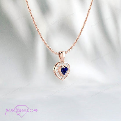 Close-up view of Blue Sapphire Heart Pendant, set in sterling silver with CZ halo.