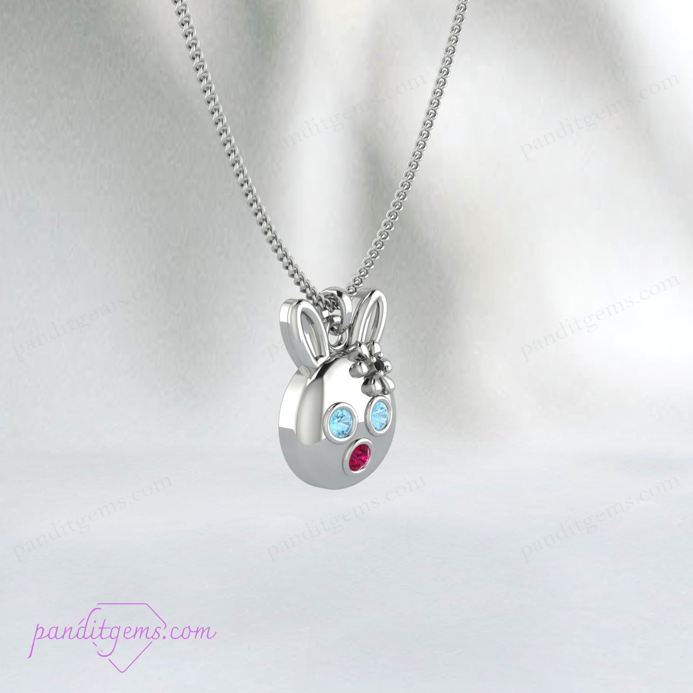 Cute bunny pendant with Aquamarine, Ruby, and Onyx on a sterling silver chain, handcrafted with precision.