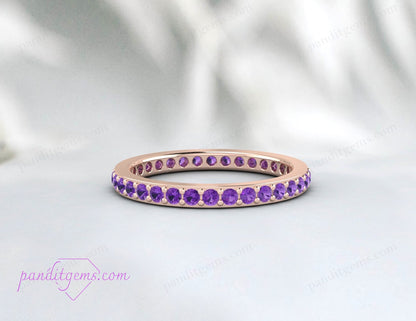 Dainty amethyst eternity wedding band in 14k rose gold, designed for stacking. The 2mm round stones symbolize eternal love and commitment.