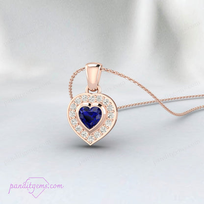 Dainty heart-shaped sapphire necklace in sterling silver, featuring a halo of cubic zirconia.