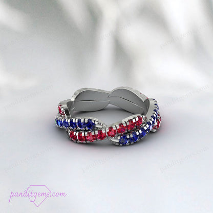 Detailed view of Blue Sapphire and Ruby gemstones set in a twisted infinity band made of 925 sterling silver.