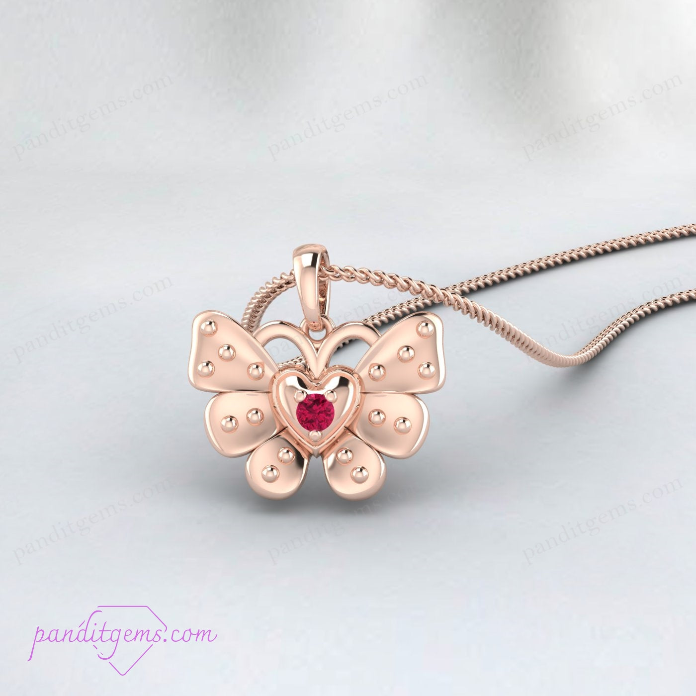 Detailed view of a 925 sterling silver butterfly charm with a ruby.