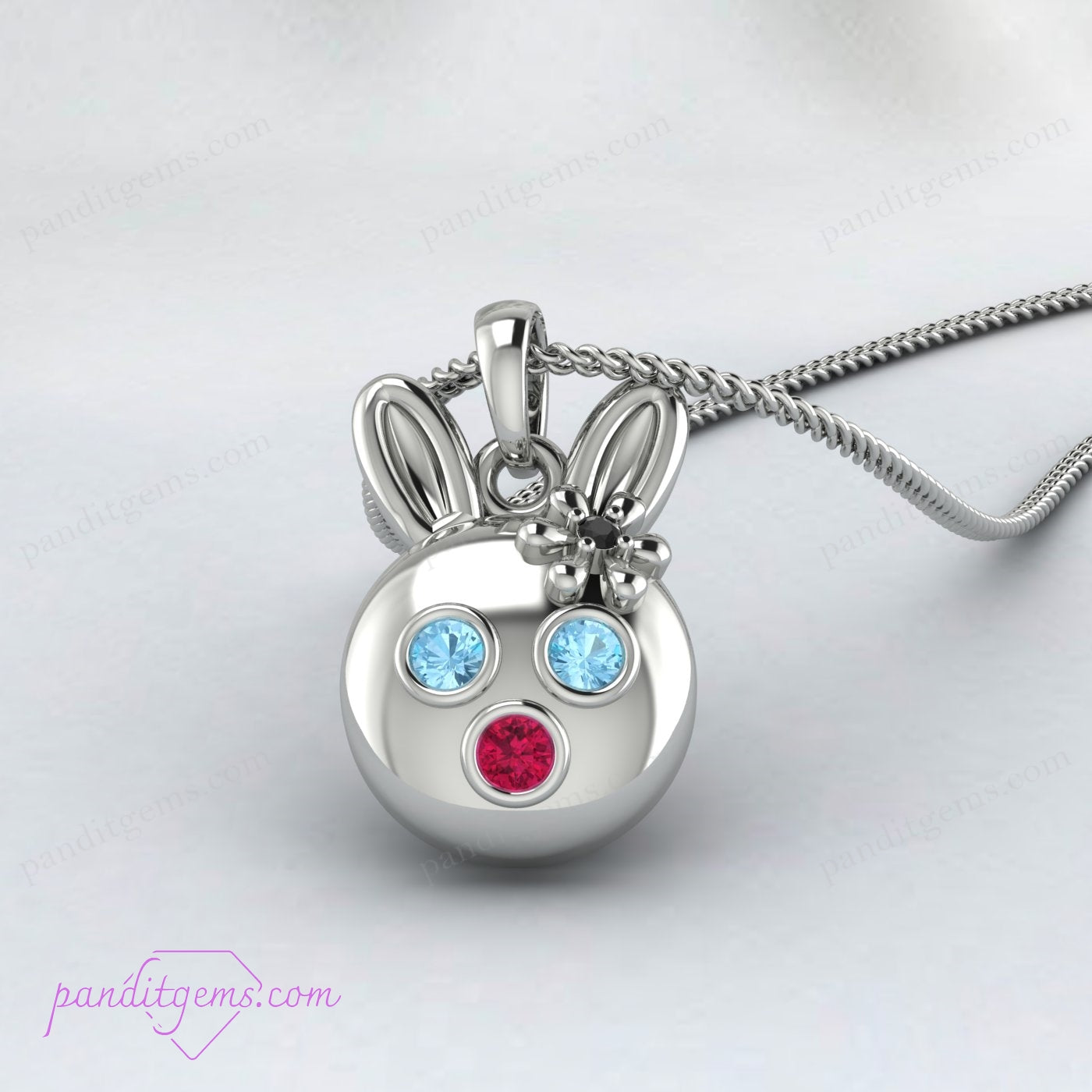 Elegant rabbit necklace in sterling silver featuring Aquamarine, Ruby, and Onyx stones, with optional gold accents.
