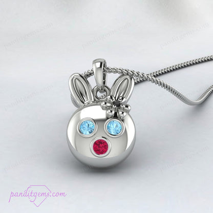 Elegant rabbit necklace in sterling silver featuring Aquamarine, Ruby, and Onyx stones, with optional gold accents.