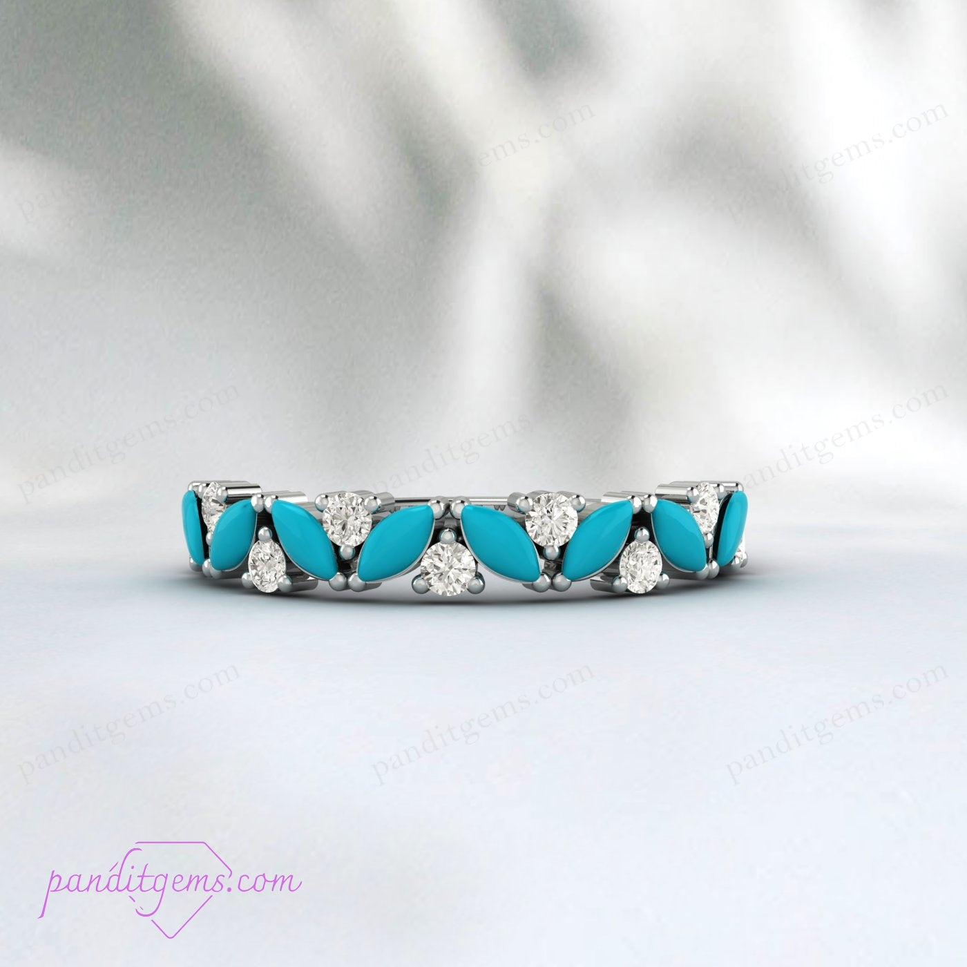 An elegant turquoise promise ring featuring a marquise cut stone and a cluster matching band