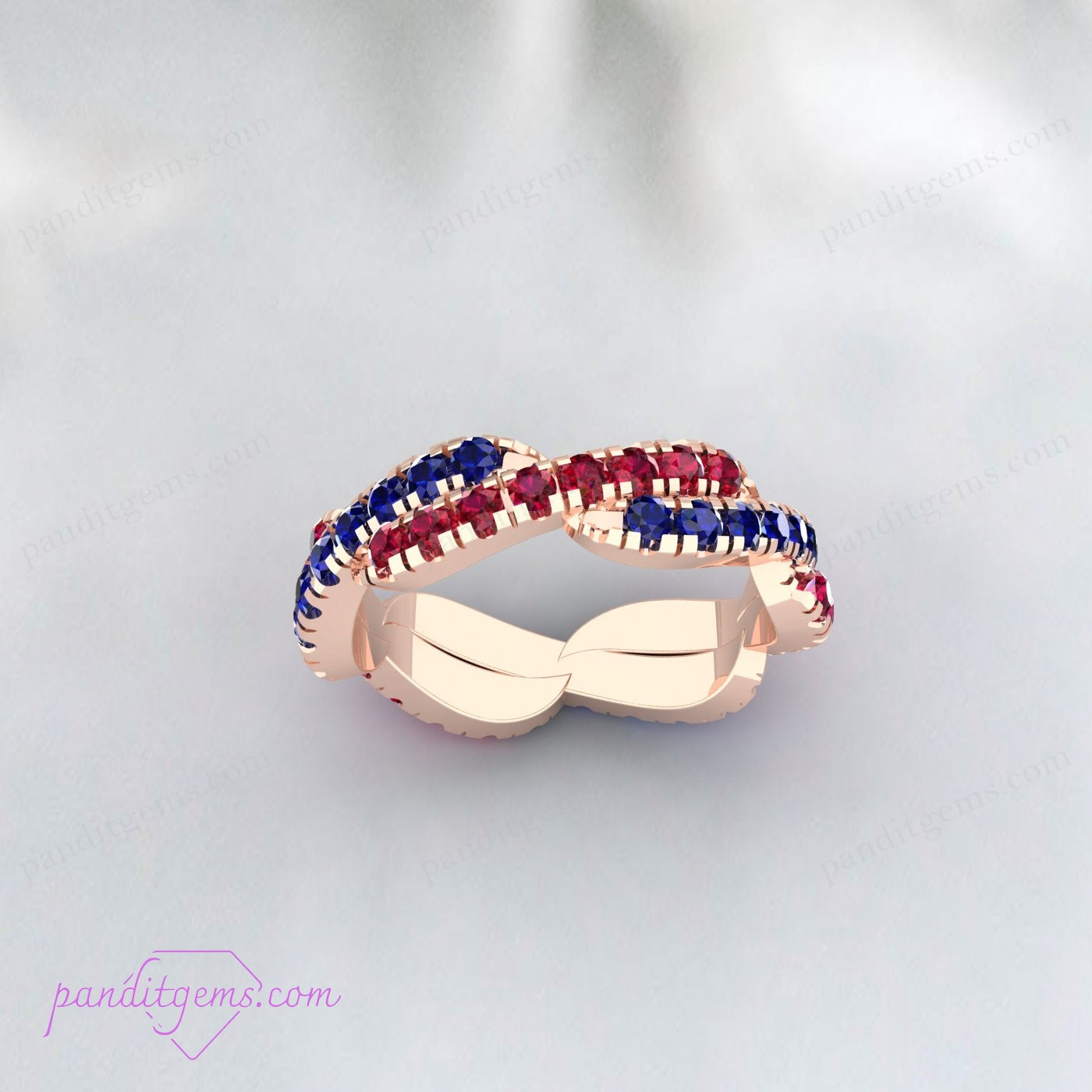 Elegant twisted wedding band with Blue Sapphire and Ruby gemstones, crafted in sterling silver.