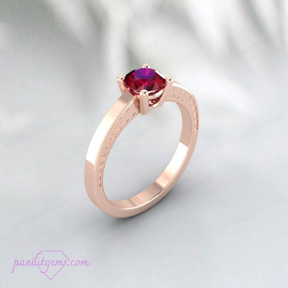 Gold-filled engagement ring with round ruby centerpiece.