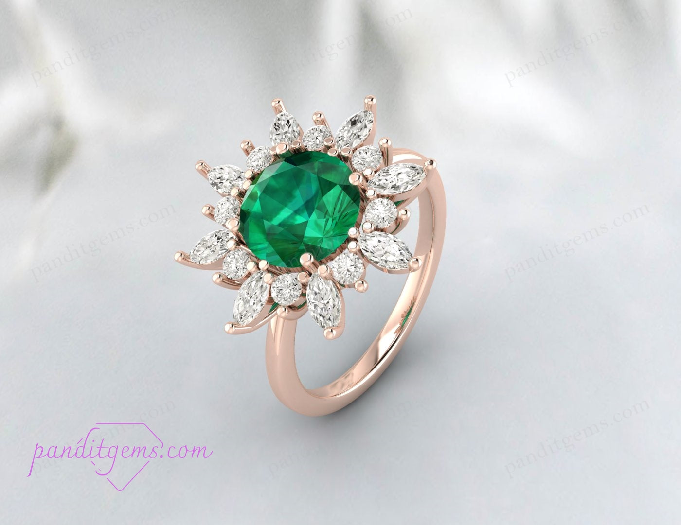 Detailed image of the halo setting featuring a round cut emerald and marquis cut diamonds.