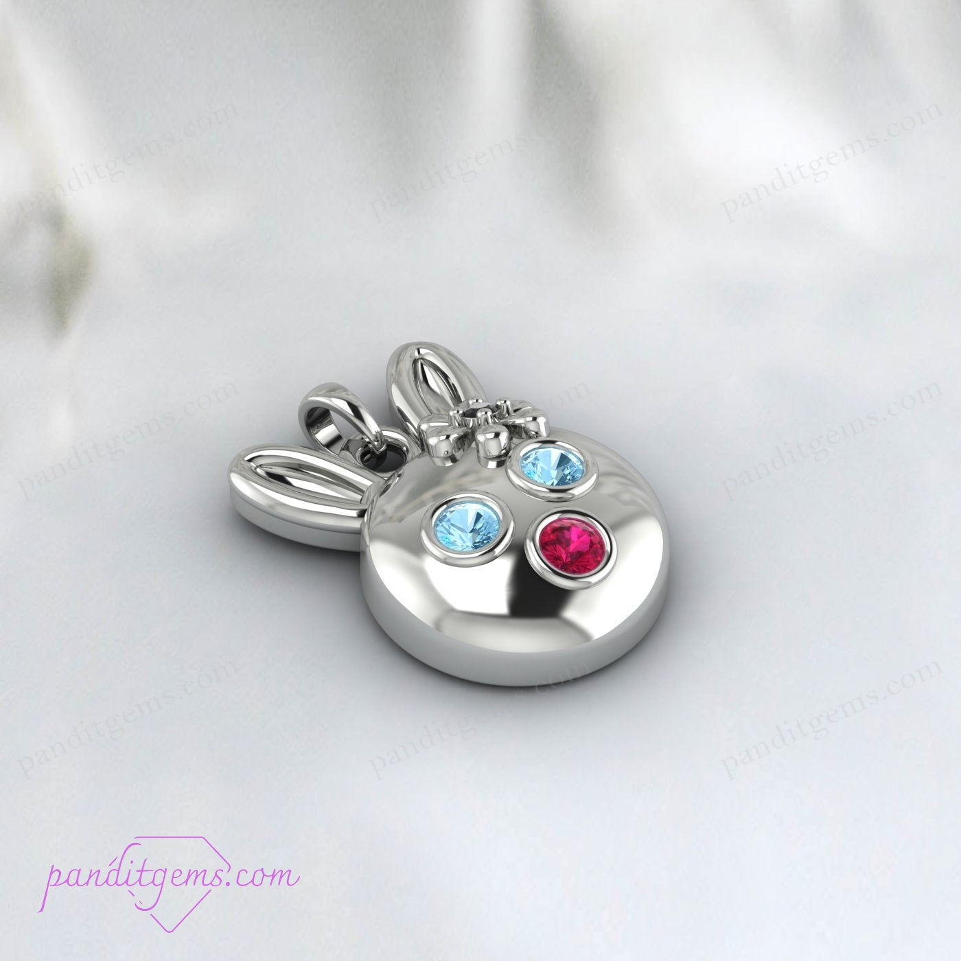 Handcrafted sterling silver bunny necklace with Aquamarine, Ruby, and Onyx, accented with 14k gold for a luxurious touch.