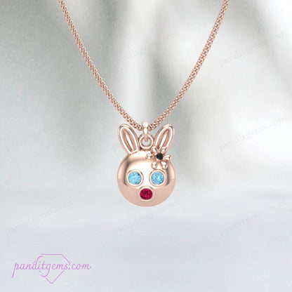 Handcrafted sterling silver bunny pendant adorned with Aquamarine, Ruby, and Onyx gemstones on a delicate chain.