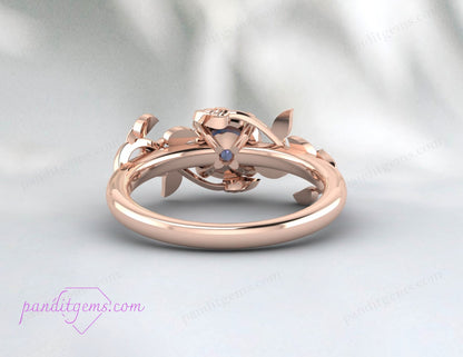 A round Alexandrite gemstone set in a rose gold-plated vine leaf ring.