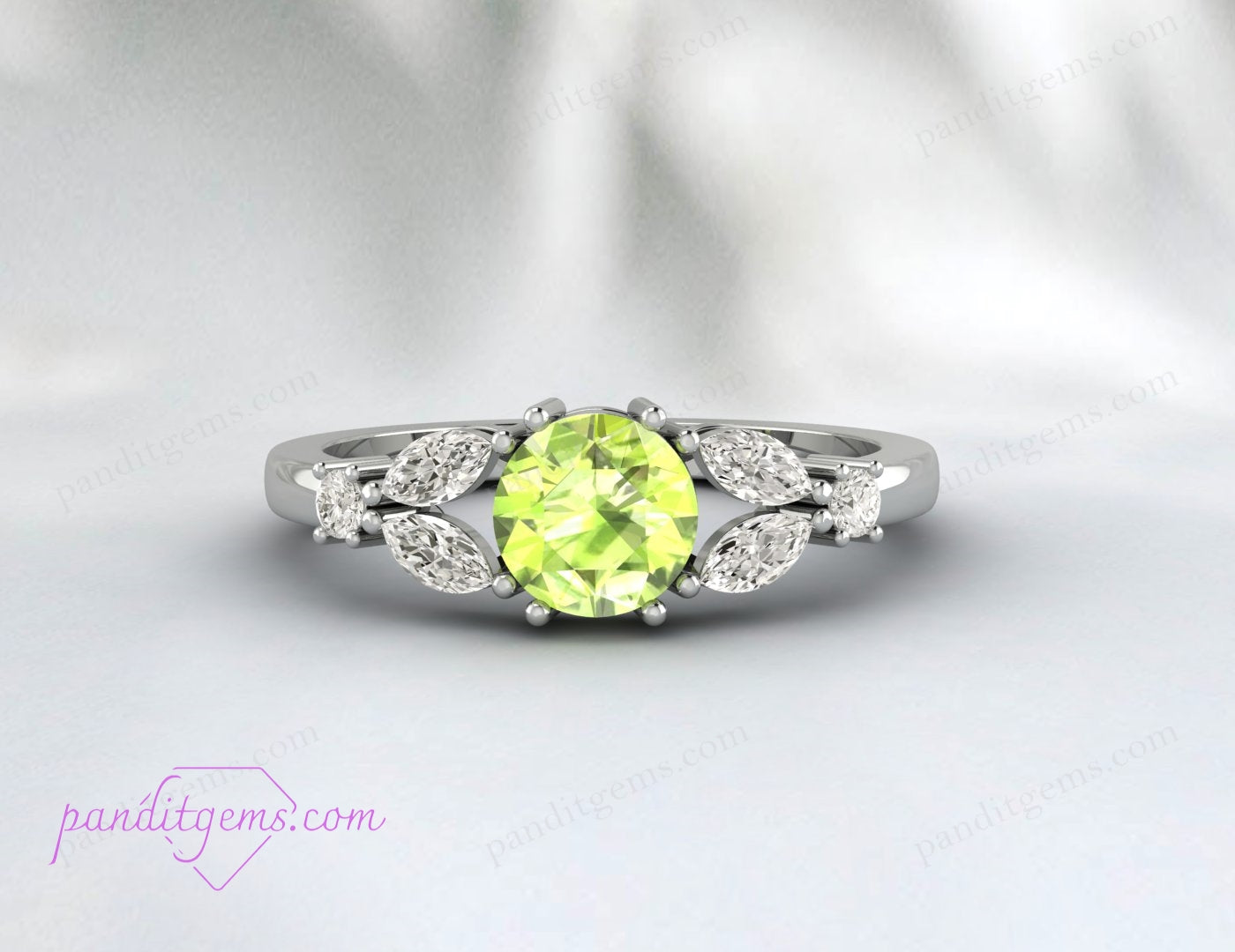 Detailed image of the leafy design with a round peridot and marquis diamonds.