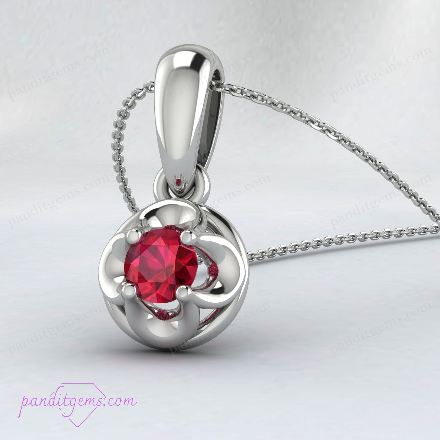 A minimalist gold necklace featuring a round cut ruby in a solitaire design.