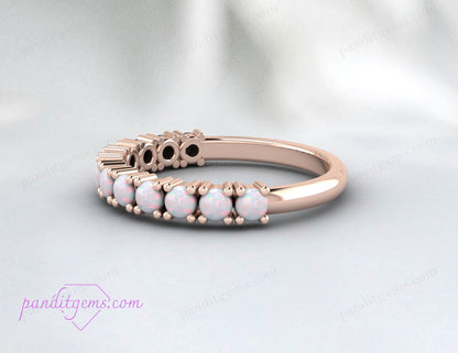 Opal eternity ring symbolizing emotional balance and creativity for October birthdays.
