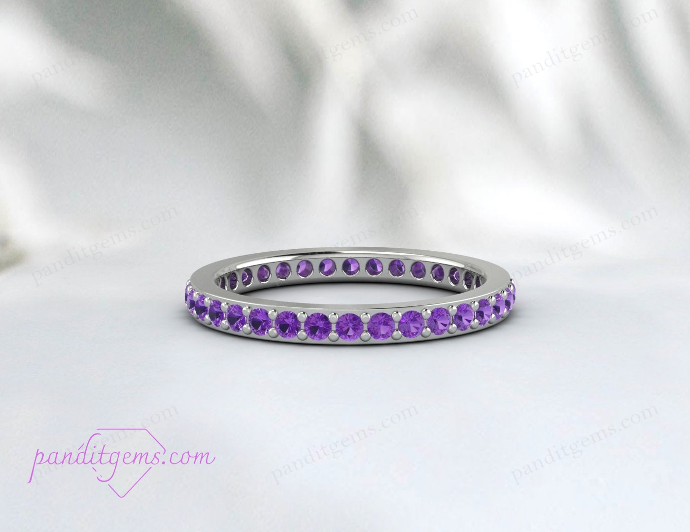 Petite amethyst wedding band in sterling silver, featuring continuous round stones for a full eternity design. Ideal as a stacking or bridal ring.
