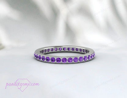 Petite amethyst wedding band in sterling silver, featuring continuous round stones for a full eternity design. Ideal as a stacking or bridal ring.